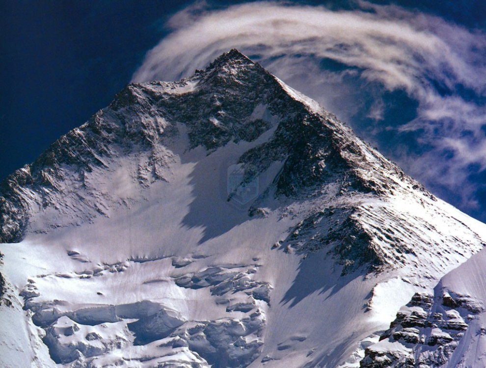 Entre la frontera de Pakistán y Xinjiang, distrito occidental de China, también conocido como Hidden Peak . Es una cima trágica para el montañismo español, en 1990 cinco escaladores españoles perdieron la vida tras alcanzar su cumbre. El 5 de julio de 1958 dos escaladores americanos fueron los primeros en llegar a la cima.
