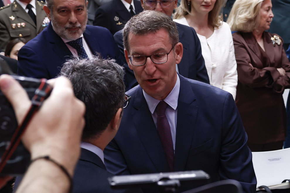 El presidente del PP, Alberto Núñez Feijóo (d), saluda al ministro de la Presidencia, Relaciones con las Cortes y Memoria Democrática, Félix Bolaños (i), durante el acto de entrega de la Medalla de la Comunidad de Madrid.