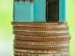 mini-house-stack-coins-with-green-blur