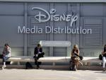 People sit next to the stand of Disney Media Distr