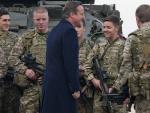 British Prime Minister David Cameron (4L) talks wi