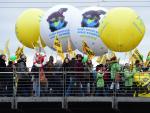 Participants hold balloons reading "Save the clima