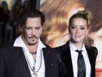 Actors Johnny Depp (L) and Amber Heard attend the