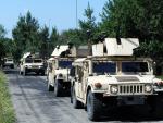 US servicemen stand on humvees as they take part i