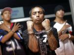 Members of the "Mara Salvatrucha" gang gesture whi