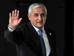 Guatemalan President Otto Perez waves at the end o
