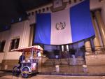 A man passes the Presidential Palace in Guatemala