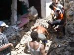 Un grupo de personas en Puerto Príncipe remueve escombros tras el terremoto que afectó a Haití el sábado.