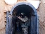 Soldado de Hamas muestra su arma en la red de túneles de Gaza.