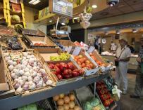 Un puesto de frutas y verduras de un mercado de abastos