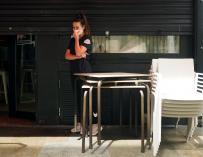 Una trabajadora en un bar de Lugo contempla el cierre de su establecimiento tras las nuevas medidas.