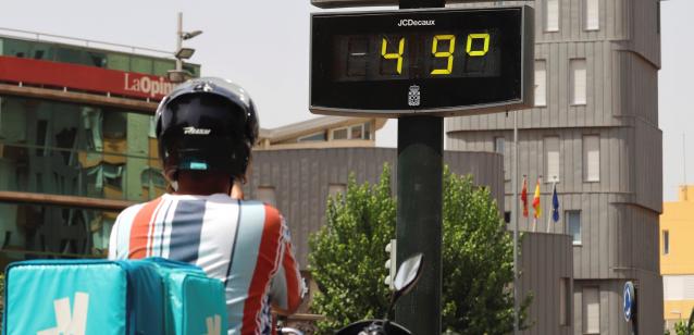 Un trabajador junto a un termómetro en Murcia durante la ola de calor.
