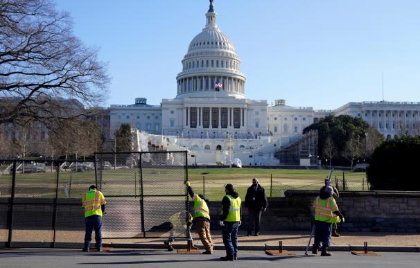 Operarios levanta una cerca en el exterior del Capitolio de los Estados Unidos tras el asalto de la pasada noche.