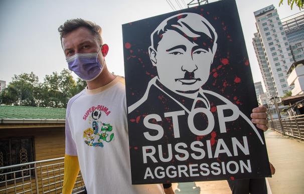 27 February 2022, Thailand, Bangkok: A protester holds a placard with a portrait of Vladimir Putin during a demonstration at the Lumphini park against the Russian invasion of Ukraine. Photo: Peerapon Boonyakiat/SOPA Images via ZUMA Press Wire/dpa Peerapon Boonyakiat/SOPA Images / DPA 27/2/2022 ONLY FOR USE IN SPAIN