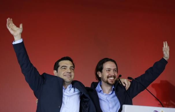 Greek head of Syriza party, Tsipras and Podemos party Secretary General Iglesias wave to supporters following a campaign rally in central Athen