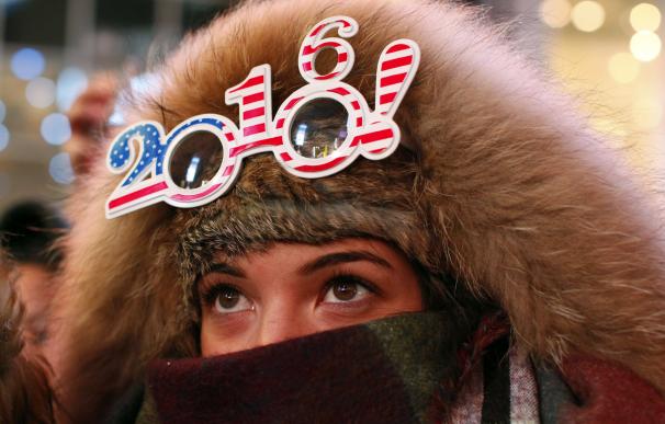 A reveler wears 2016 glasses at New Year's Eve cel