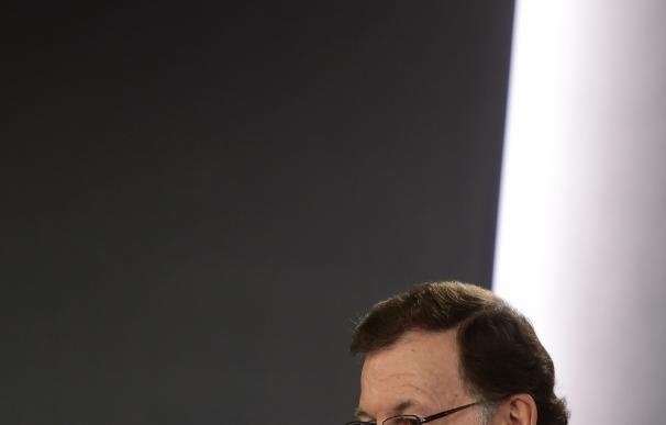 Spanish Prime Minister Mariano Rajoy listens to a