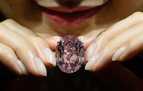Una modelo posa con el diamante Pink Star, de 59.60 quilates. (Anthony Wallace / AFP)