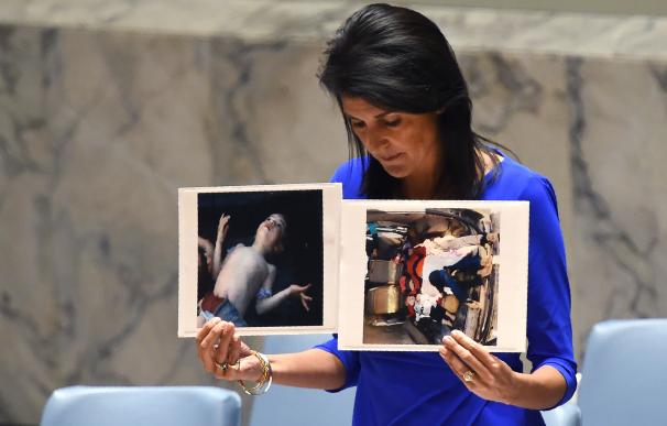 La embajadora estadounidense ante la ONU, Nikki Haley, sostiene en sus manos imágenes del ataque químico en Siria durante su intervención en la ONU. Timothy A.Clary/AFP