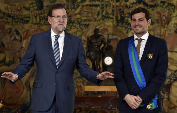 Spanish Prime Minister Mariano Rajoy poses beside