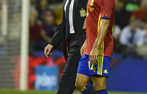 Spain's midfielder Thiago (R) leaves the pitch due