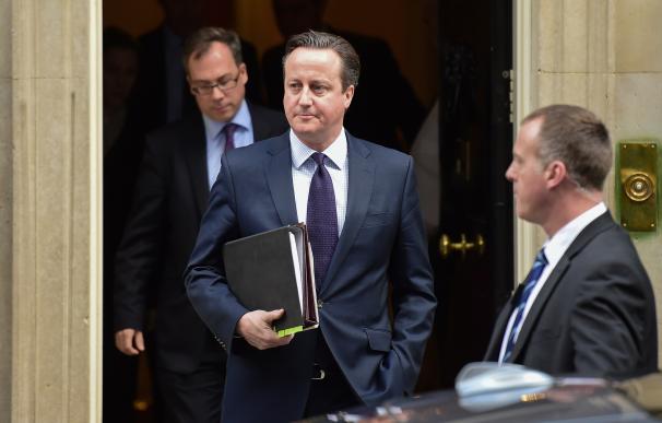British Prime Minister David Cameron (C) leaves 10