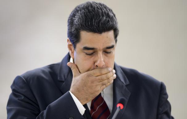 Venezuela's President Nicolas Maduro reacts as he