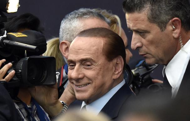 Italy's former Prime Minister Silvio Berlusconi ar