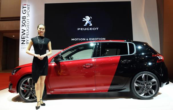 A model stands beside the new 308 GTi by Peugeot S