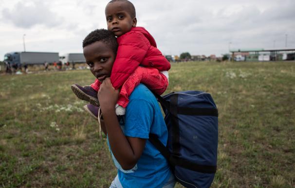 Refugee children from Sudan walk on their way to A