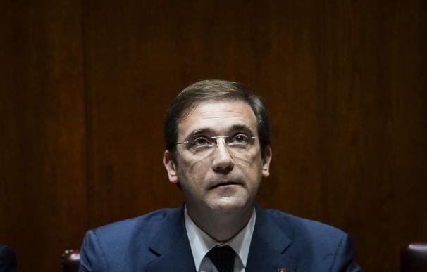 Portuguese Prime Minister Pedro Passos Coelho sits