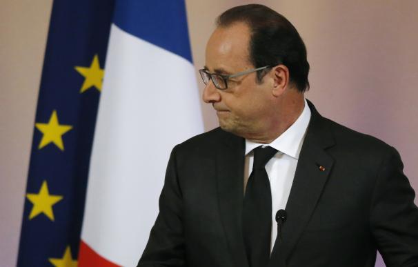 French President Francois Hollande leaves after ad