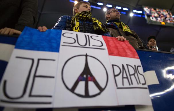 Fans display a placard with "I am Paris" on it pri
