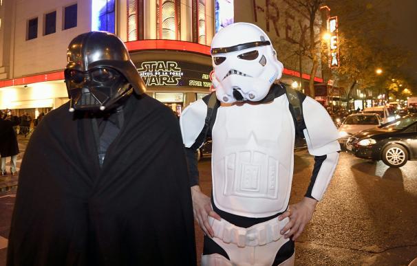 People wearing Star Wars character costumes wait a