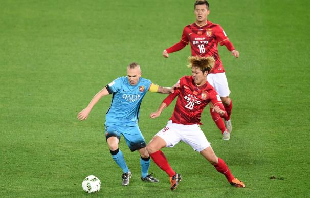 Barcelona forward Andres Iniesta (L) and Guangzhou