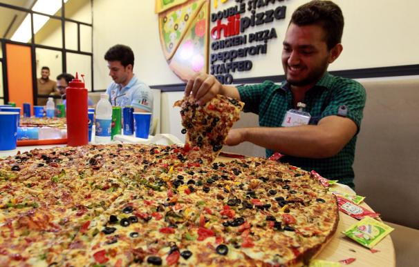 Iraqi men takes part in a pizza eating contest in