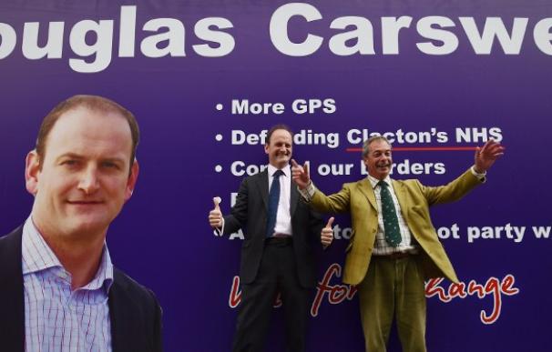Douglas Carswell posa con Nigel Farage, líder de UKIP, delante de un cartel del partido