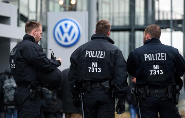 Police officers stand at the entrance of the Volks