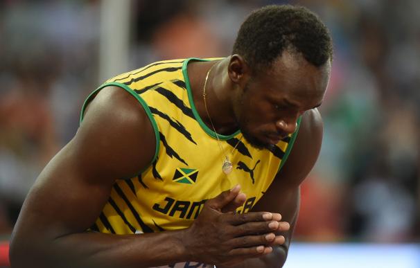Jamaica's Usain Bolt reacts in the semi-final of t