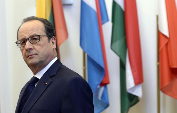 French President Francois Hollande listens to a qu