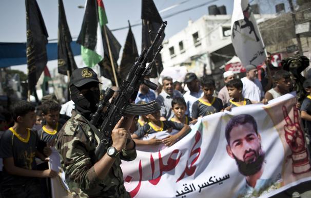 An Islamic Jihad fighter leads a march organized b