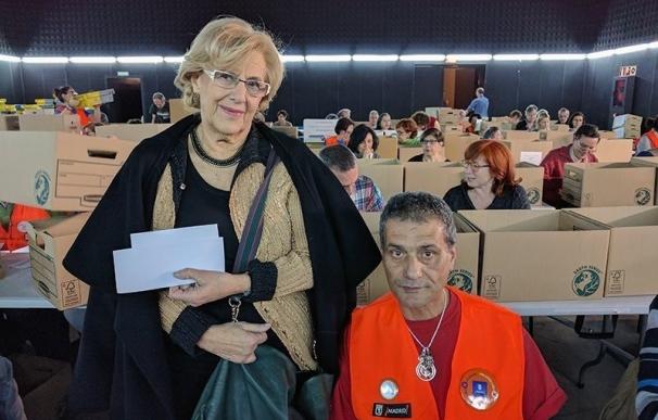 Carmena visita a los voluntarios que están llevando el recuento de las papeletas de la votación ciudadana