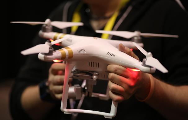 A DJI drone is held at The CES Unveiled press even