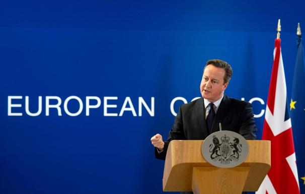 British prime minister David Cameron gestures as h