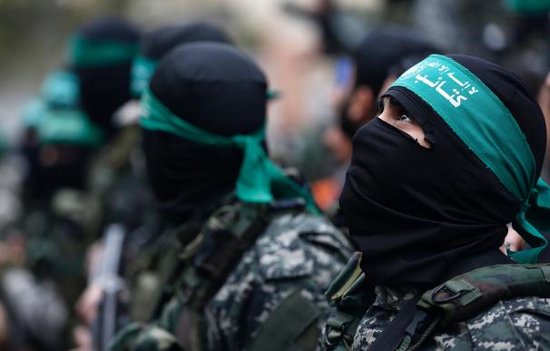 Palestinian Hamas militants attend a funeral proce