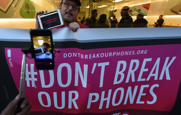 Protesters demonstrate outside an Apple Store as t