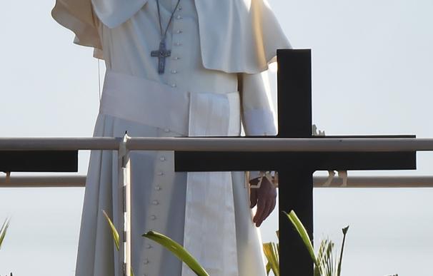 Pope Francis waves on a platform in Mexico as he b