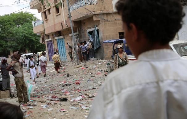 Yemenis look at the damage after Iran backed rebel
