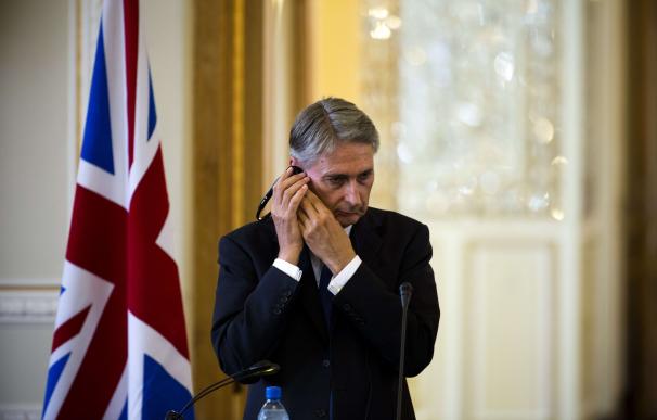 British Foreign Minister Philip Hammond holds his