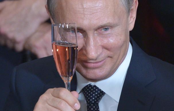 Russia's President Vladimir Putin toasts during a